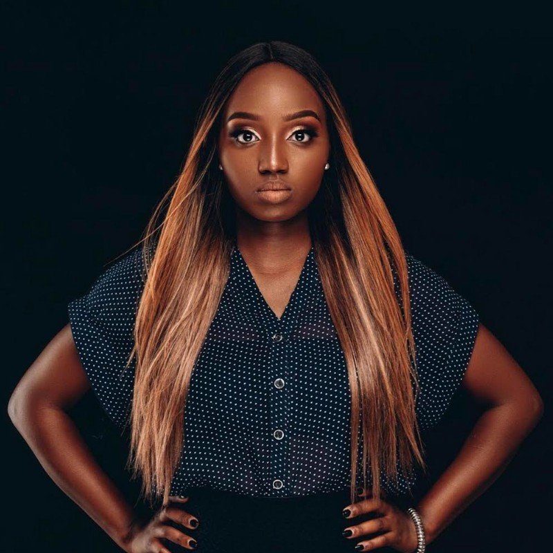 Professional African female business consultant smiling confidently in office setting